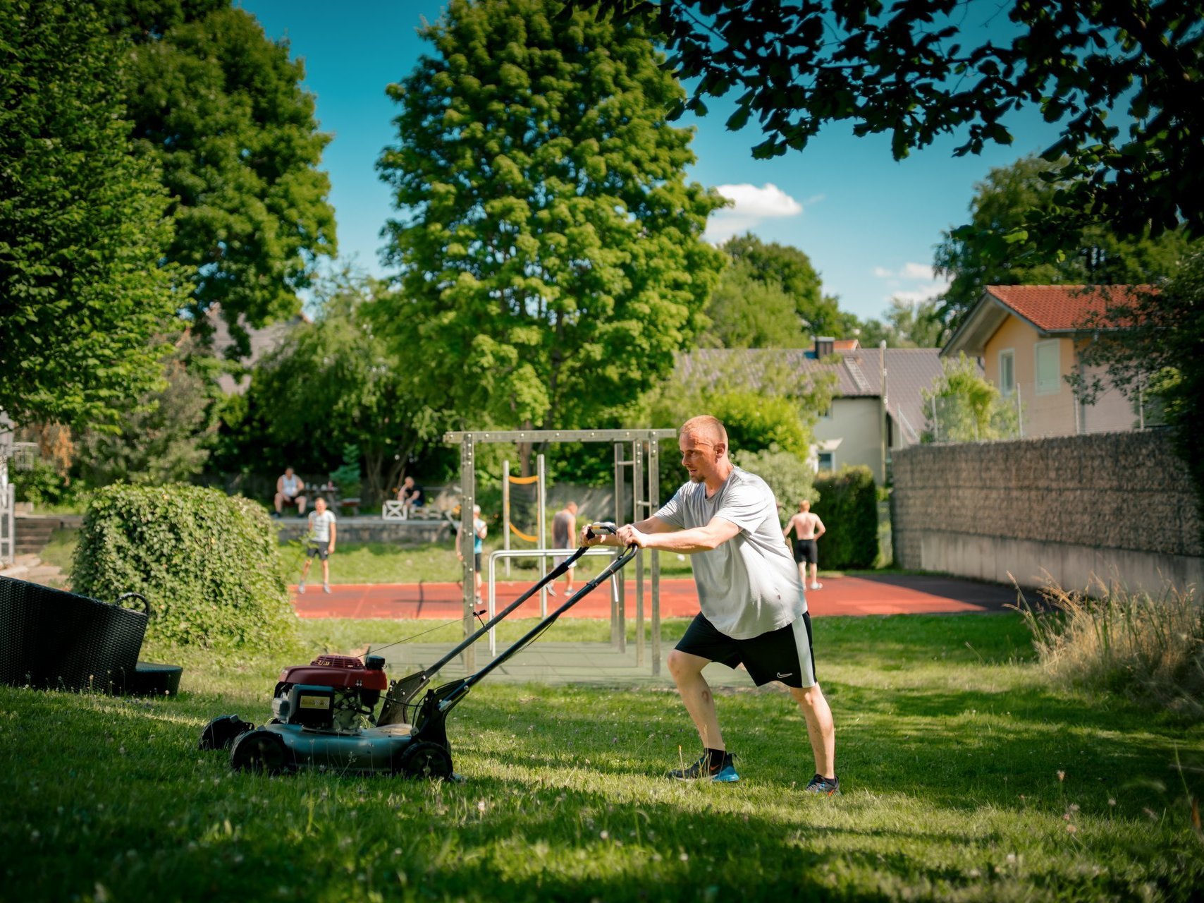 Ein Mann mäht Rasen.